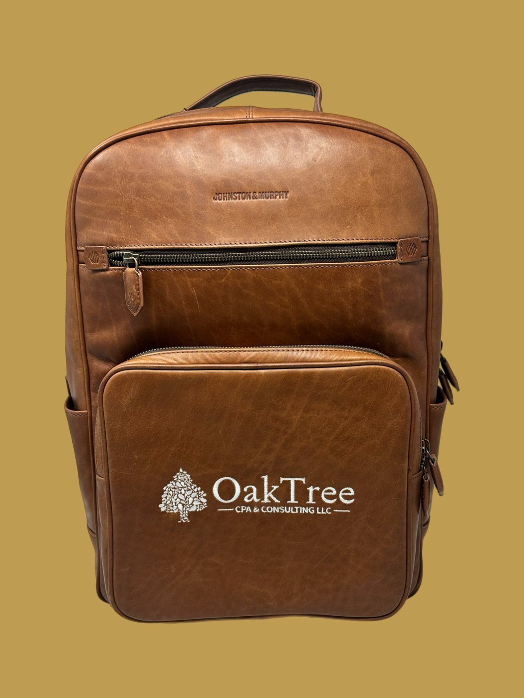 Oak Tree CPA logo embroidered on a customer&rsquo;s leather backpack