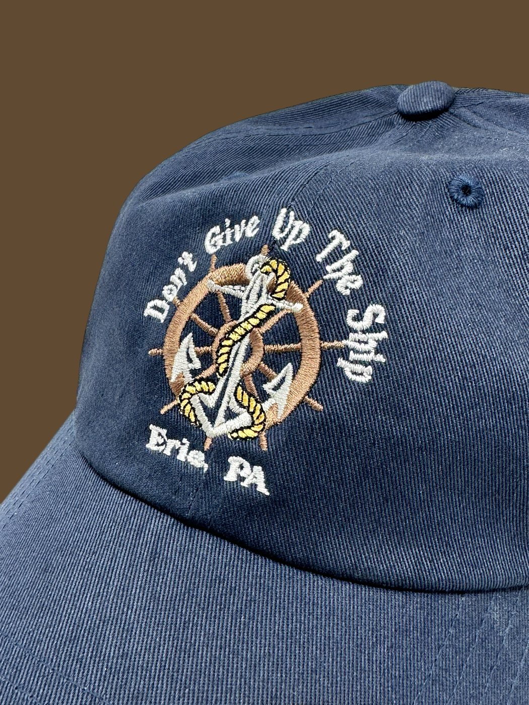 "Don't Give Up The Ship — Erie, PA" ship's wheel and anchor embroidered on a navy cap