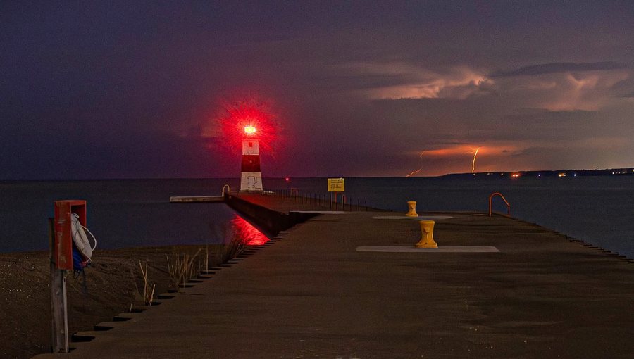 The North Pier lighthouse at Presque Isle, lightning over Lake Erie beyond