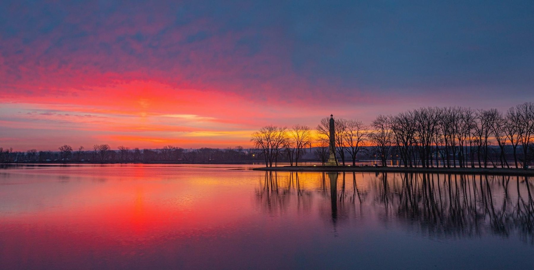 Sunset over Presque Isle Bay, with the Perry Monument silhouetted against the water
