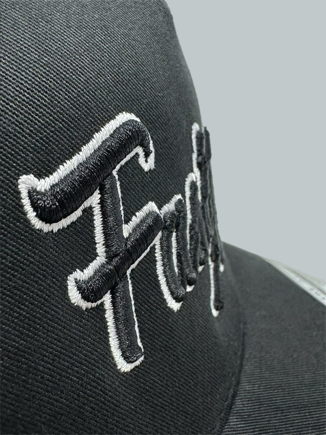Raised 3D puff lettering stitched on a black Fast Action cap